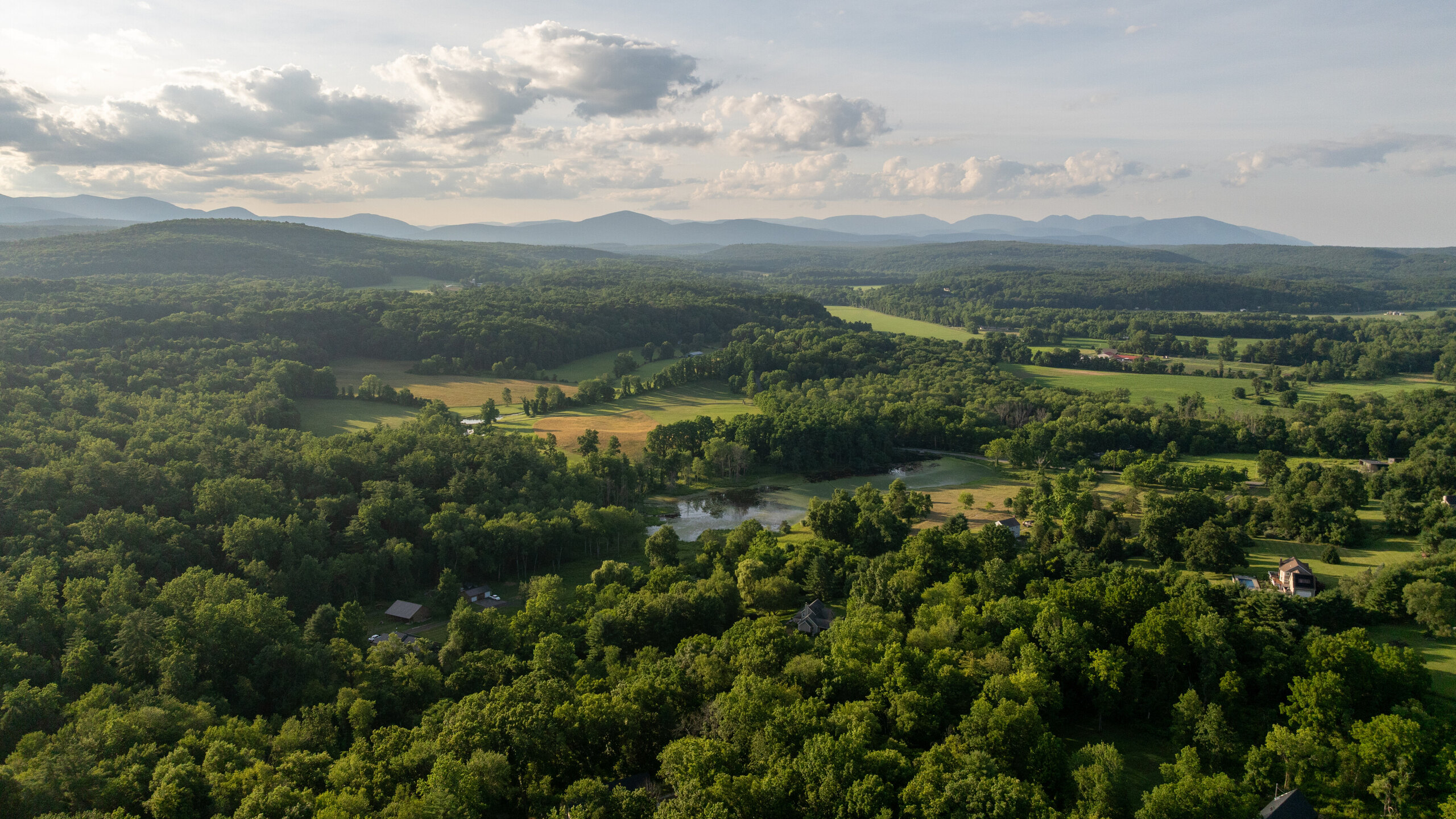 View from the ridge toward the Catskill horizon, fields and forest below